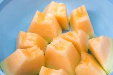 slice of melons in bowl, fresh Melon or cantaloupe, Cantaloupe melons on wood background, Favorite fruit in summer