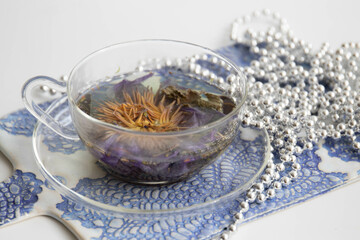 Herbal tea in rustic tea cup on White background