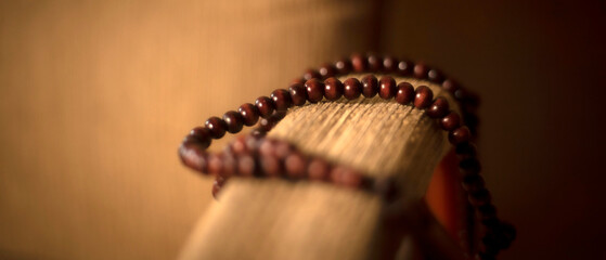 Abstract defocused rosary beads on blur background. Religion concept image