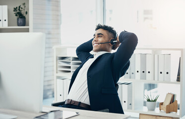 Computer, call center and stretching businessman in relief, success or done crm sales deal, telemarketing goals or crm target. Happy smile, relax and customer support worker hands behind head on tech