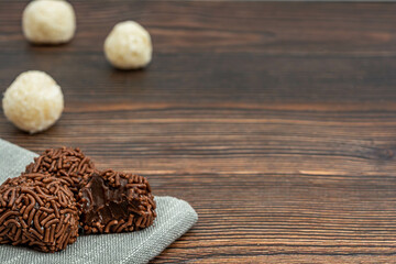 brazilian brigadeiro traditional delicious chocolate dessert, party snacks, sweet sprinkle background top view over wooden table