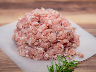 Minced pork on butcher paper with rosymary