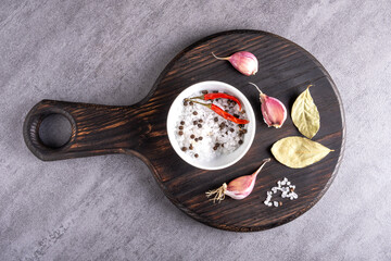 Cutting board or steak board with salt shaker and spices.