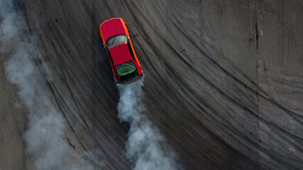Aerial top view car drifting, Race drift car with lots of smoke from burning tires on speed track,...