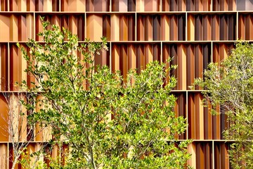 a luxury hotel's zig zag wall facade with yellow, gold, brown tone cladding 