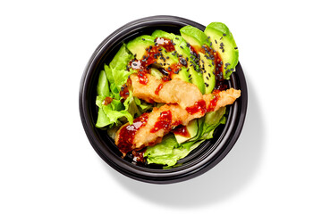 Japanese salad with lettuce, avocado and shrimps tempura dressed with mirin sauce and black sesame