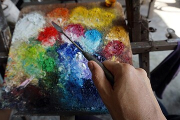  hand holding a drawing Knife Trowel    