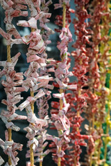 Close up of colorful omikuji tie at Sankoinari Shrine at Inuyama Castle, Aichi, Japan. The Omikuji tie is made to drive away bad luck, but if getting a good Omikuji, it's not necessary to tie it.
