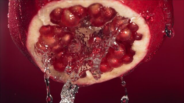 Slow Motion of Flowing Water from Half Pomegranate