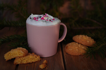 Christmas drink with homemade cookies on a wooden table