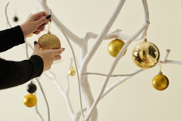Woman Decorating Tree with Baubles