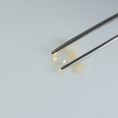 genuine mined natural opal oval cabochon precious gemstones for design gems jewellery. Selective focus natural opal oval cabochon gemstone for design gold jewelry.