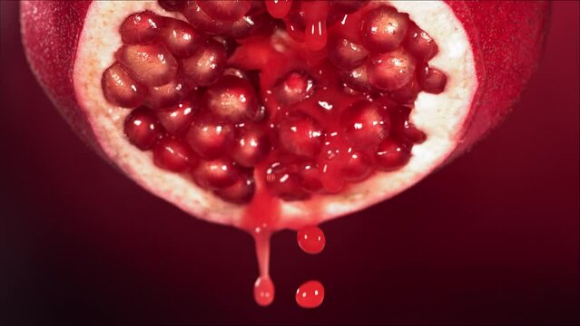 Slow Motion of Juice Drip Drop from Half Pomegranate