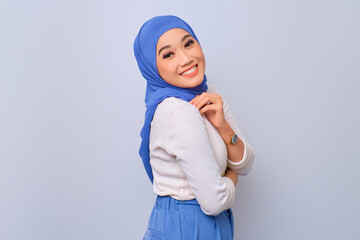 Young beautiful Asian Muslim woman feeling confident and smiling happy isolated over white background