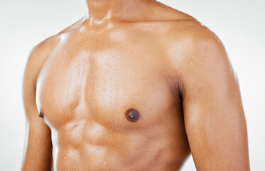 Fototapeta premium Fitness, man and chest in studio closeup for health, wellness and muscle against a white background with mockup. Stomach, skincare and guy model torso for six pack, beauty and grooming with mock up
