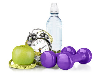 Green alarm clock, apple, bottle of water,  measuring tape and dumbbells as concept of diet - isolated on white