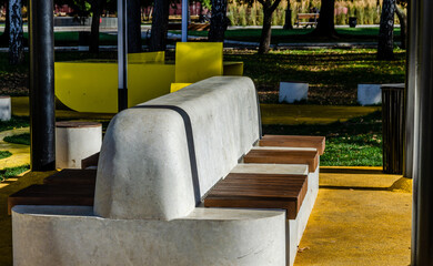Fototapeta na wymiar Concrete bench in the park in autumn.