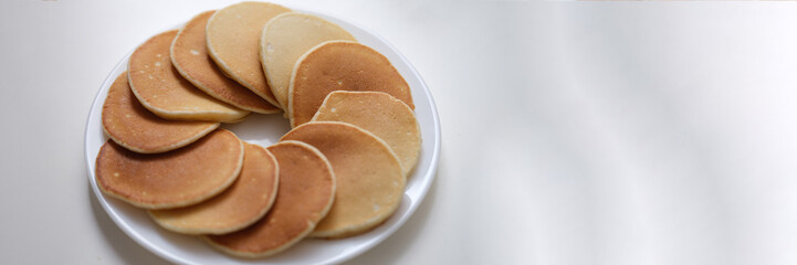 Flour sweet round fritters on white plate closeup