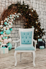 Blue chair in the Christmas interior. Christmas Arch with balloons