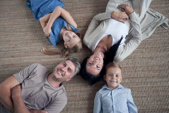 Family lying on floor with heads together at home