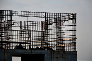 Obraz premium houses built of reinforced steel concrete are earthquake resistant and can be several stories high. wire mesh is braided and poured with concrete from the mixer, rusty, rust, stop, 