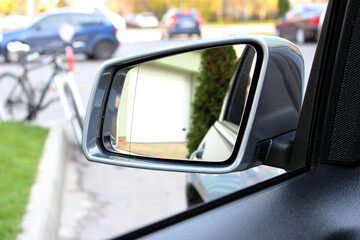Rear view mirror with beautiful reflection. View from inside the car. Side rear-view mirror on a modern car. Close up rearview mirror lux car.