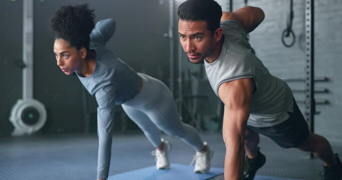 Fitness, gym and dumbbell, people doing weightlifting and exercise for body training with focus and strong muscle. Man, woman and workout on mat, endurance and serious athlete for active lifestyle.