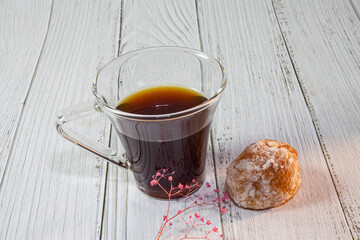 Cup of coffee on woody background.