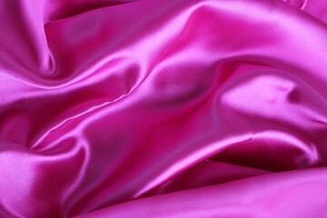 Beautiful bright pink fabric, folded in beautiful folds. Silk, satin or satin.