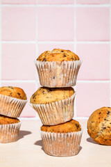 Close-up of chocolate and banana muffins in stack, colorful background, hard light