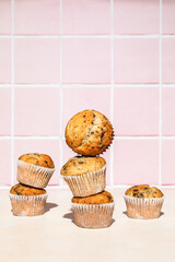 Chocolate and banana muffins in stack, colorful background, hard light