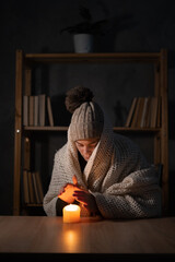 Woman suffers in no heating and no electricity during an energy crisis in Europe causing blackouts....