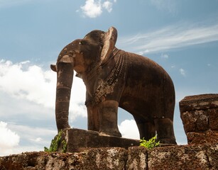 Fototapeta na wymiar Statue of an elephant in the ruins of historical Angkor Wat temple in the woods, Cambodia