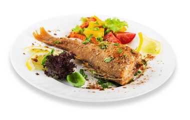 Grilled fish with vegetables on white plate