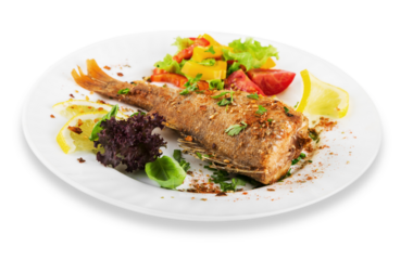 Grilled fish with vegetables on white plate
