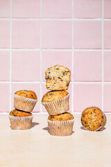 Chocolate and banana muffins in stack, colorful background, hard light