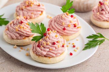 Italian canapes with mortadella and ricotta cream mousse or Spuma di mortadella on a small tigelle bread. Appetizer or snacks for a festive table.