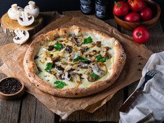 Mushroom pizza with addition mozzarella cheese and herbs on a wooden table