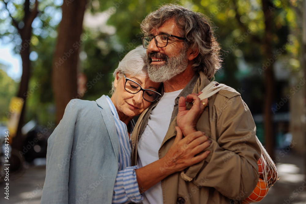 Wall mural Loving senior couple outdoors.