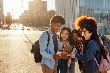 Students using smartphone outdoors.