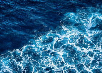 Aerial view to seething waves with foam. Waves of the sea meet each other during high tide and low tide - 542350361