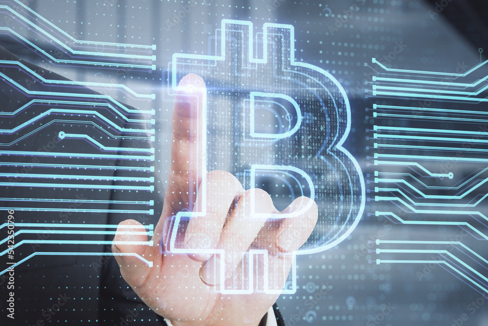 Poster close up of businessman hand pointing at creative bitcoin hologram on blurry office interior backgro