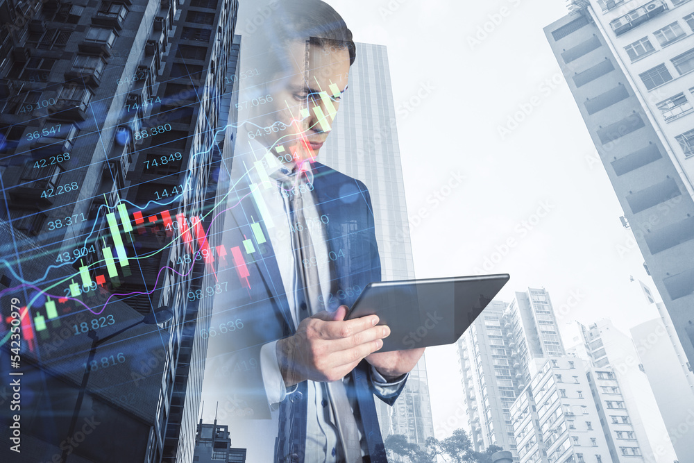 Aufkleber businessman using tablet with creative candlestick forex chart index hologram on blurry background. 