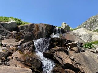 Mountain waterfalls and cascades of alpine streams in the area of the mountain Gotthard Pass (Gotthardpass) in the Swiss Alps, Airolo - Canton of Ticino (Tessin), Switzerland (Schweiz)