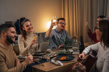 friends singing and playing guitar on gathering on home dinner party