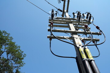Obraz premium High Voltage Electric Pole with Blue Sky.