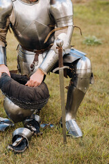 Close-up of a medieval knight in armor preparing for battle