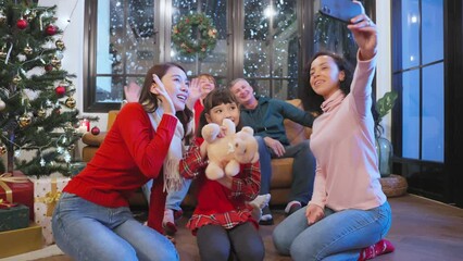 Multi-ethnic big family use mobile phone video call online to relative.	 - Powered by Adobe