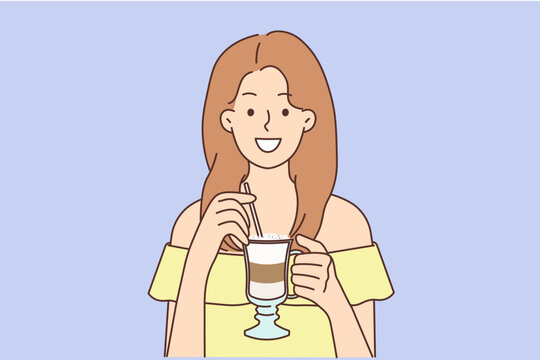 Smiling woman drinking late coffee with straw