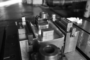 Sheet Metal Stamping Tool Die for Automotive Precision Parts on The Numerical Control Milling Machine Table. Tandem Stamping System. At a High Quality Technology Factory. Black and White Photography.